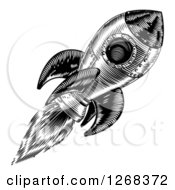 Clipart Of A Black And White Engraved Rocket In Flight Royalty Free Vector Illustration