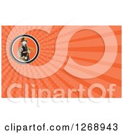 Clipart Of A Retro Fireman Holding An Axe Over An Orange Ray Business Card Design Royalty Free Illustration