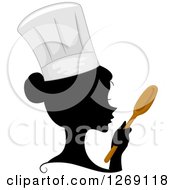 Clipart Of A Silhouetted Black Chef Womans Face With A Colored Spoon And Hat Royalty Free Vector Illustration by BNP Design Studio