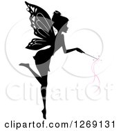 Silhouetted Black And White Flying Fairy Using A Magic Wand With Pink Waves