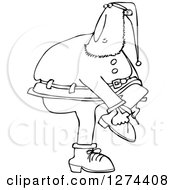 Clipart Of A Black And White Christmas Santa Clause Trying To Put On A Boot Royalty Free Vector Illustration