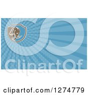 Clipart Of A Retro Brown Woodcut Elephant And Blue Rays Business Card Design Royalty Free Illustration
