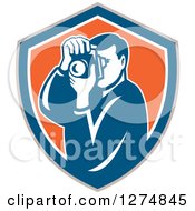 Poster, Art Print Of Retro Male Photographer Taking Pictures In A Taupe Blue White And Orange Shield