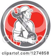 Clipart Of A Retro Mechanic Man Holding A Giant Spanner Wrench In A Taupe White And Red Circle Royalty Free Vector Illustration
