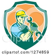 Clipart Of A Retro Mechanic Man Holding A Spanner Wrench In A Green White And Orange Shield Royalty Free Vector Illustration