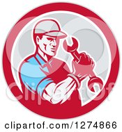 Clipart Of A Retro Mechanic Man Holding A Spanner Wrench In A Red White And Gray Circle Royalty Free Vector Illustration