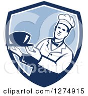 Male Chef Holding A Bowl Of Soup In A Blue And White Shield