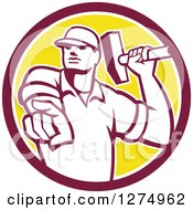 Retro Demolition Worker Man Holding A Hammer And Pointing Outwards In A Maroon White And Yellow Circle