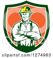 Retro Male Electrician Or Construction Worker With Folded Arms In A Green White And Orange Shield