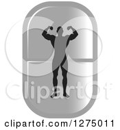 Poster, Art Print Of Black Silhouetted Male Bodybuilder Flexing Over A Silver Pill