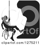 Clipart Of A Black And White Silhouetted Female Mountain Climber Rapelling Royalty Free Vector Illustration by Lal Perera