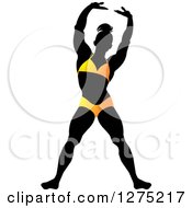 Clipart Of A Silhouetted Stretching Female Bodybuilder In A Yellow Suit Royalty Free Vector Illustration