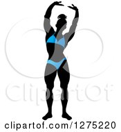 Poster, Art Print Of Silhouetted Stretching Female Bodybuilder In A Blue Suit