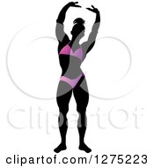 Poster, Art Print Of Silhouetted Stretching Female Bodybuilder In A Purple Suit