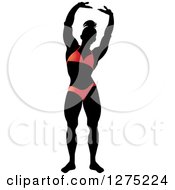 Poster, Art Print Of Silhouetted Stretching Female Bodybuilder In A Red Suit