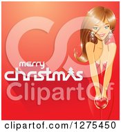 Poster, Art Print Of Merry Christmas Greeting With A Beautiful Caucasian Woman Holding A Heart On A Red Background