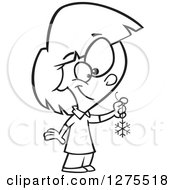 Cartoon Clipart Of A Black And White Happy Girl Holding A Snowflake Christmas Decoration Royalty Free Vector Line Art Illustration