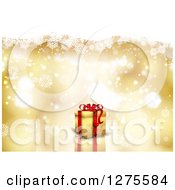 Poster, Art Print Of 3d Christmas Gift Over A Gold Snowflake And Flare Background