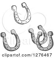 Clipart Of Black And White And Grayscale Horseshoes Royalty Free Vector Illustration by Hit Toon