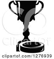 Clipart Of A Black And White Trophy Cup And Hockey Puck 2 Royalty Free Vector Illustration