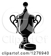 Clipart Of A Black And White Trophy Cup And Hockey Puck 3 Royalty Free Vector Illustration