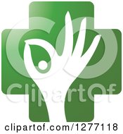 Clipart Of A White Silhouetted Hand And Pill In A Green Cross Royalty Free Vector Illustration by Lal Perera