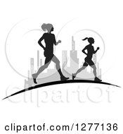Poster, Art Print Of Silhouetted Women Running Over A Grayscale City