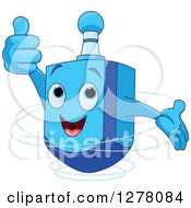 Happy Blue Dreidel Top Toy Holding A Thumb Up And Spinning