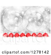 Poster, Art Print Of Christmas Background Of 3d Red Ornaments In A Row In Snow Over Silver Bokeh And Snowflakes