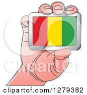 Caucasian Hand Holding A Guinea Flag