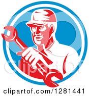Poster, Art Print Of Retro Male Mechanic Holding Out A Wrench In A Blue And White Circle