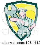 Poster, Art Print Of Retro Cartoon Male Mechanic With His Arm Around A Giant Wrench In A Green White And Yellow Shield