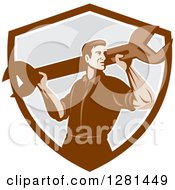 Poster, Art Print Of Retro Male Mechanic With A Giant Wrench On His Shoulders In A Brown White And Gray Shield