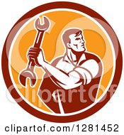 Poster, Art Print Of Retro Muscular Male Mechanic Holding A Wrench In A Red White And Orange Circle