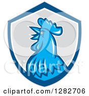 Clipart Of A Retro Crowing Rooster In A Gray Blue And White Shield Royalty Free Vector Illustration