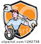 Poster, Art Print Of Cartoon Male Mechanic Worker Holding A Giant Wrench And A Tire In A Black White And Orange Shield