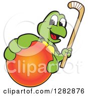 Happy Turtle School Sports Mascot Character Holding Out A Field Hockey Ball And Stick