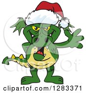 Clipart Of A Friendly Waving Green Dragon Wearing A Christmas Santa Hat Royalty Free Vector Illustration