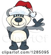 Clipart Of A Friendly Waving Blue Eyed Panda Wearing A Christmas Santa Hat Royalty Free Vector Illustration