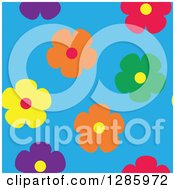 Clipart Of A Seamless Background Pattern Of Colorful Flowers On Blue Royalty Free Vector Illustration