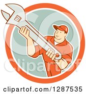Poster, Art Print Of Retro Cartoon Male Mechanic Holding An Adjustable Wrench In An Orange White And Pastel Green Circle