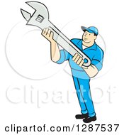 Clipart Of A Retro Cartoon Male Mechanic Holding An Adjustable Wrench Royalty Free Vector Illustration
