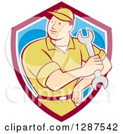 Clipart Of A Retro Cartoon Male Mechanic Holding A Wrench In A Maroon White And Blue Shield Royalty Free Vector Illustration