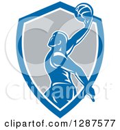 Poster, Art Print Of Retro Silhouetted Basketball Player Doing A Layup In A Blue White And Gray Shield