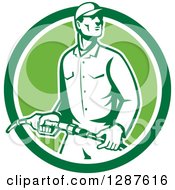 Poster, Art Print Of Retro Gas Station Attendant Jockey Holding A Nozzle In A Green And White Circle