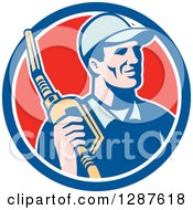 Clipart Of A Retro Gas Station Attendant Jockey Holding A Nozzle In A Blue White And Red Circle Royalty Free Vector Illustration