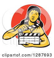 Retro Female Asian Film Crew Worker Holding A Clapper Over An Orange Circle