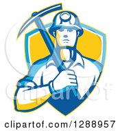 Retro Male Coal Miner Holding A Pickaxe In A Yellow Blue And White Shield