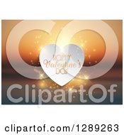 Poster, Art Print Of Happy Valentines Day Text On A White Heart With Magic Flares Over A Blurred Ocean Sunset