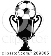 Clipart Of A Black And White Soccer Ball In A Championship Trophy Royalty Free Vector Illustration